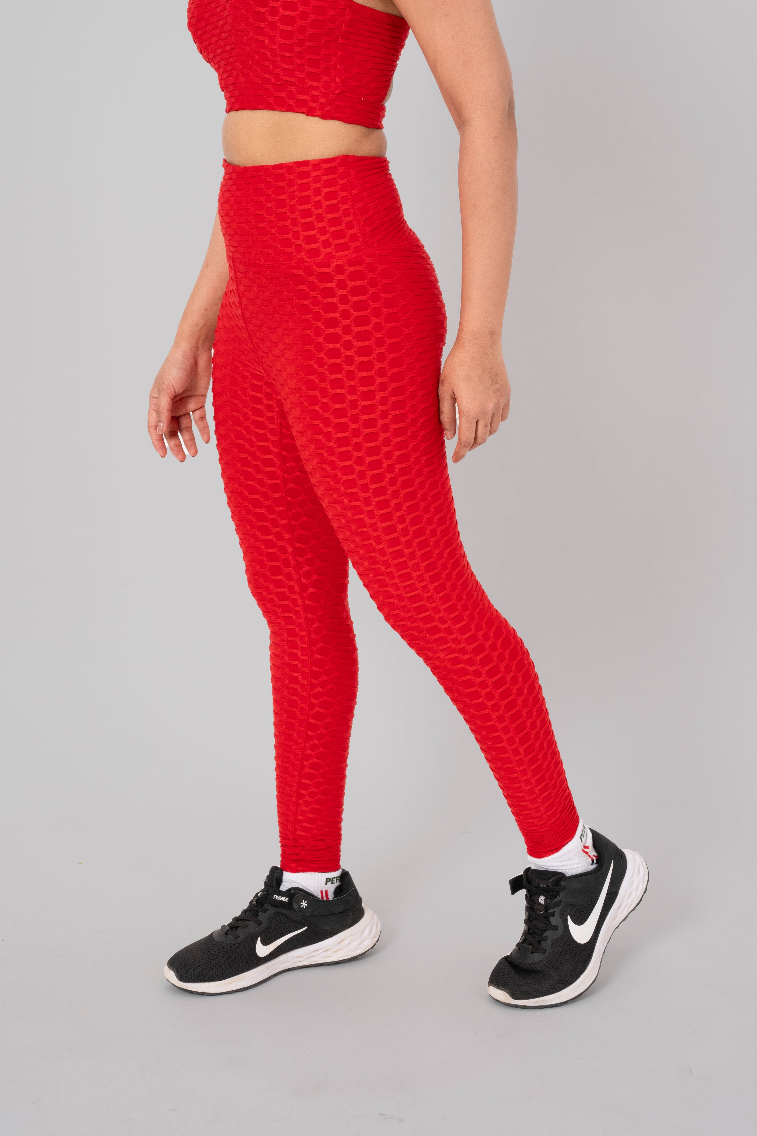 Woman in workout leggings, Red - side view standing, showing breathable fabric and anti-camel toe feature.@@@color_Red