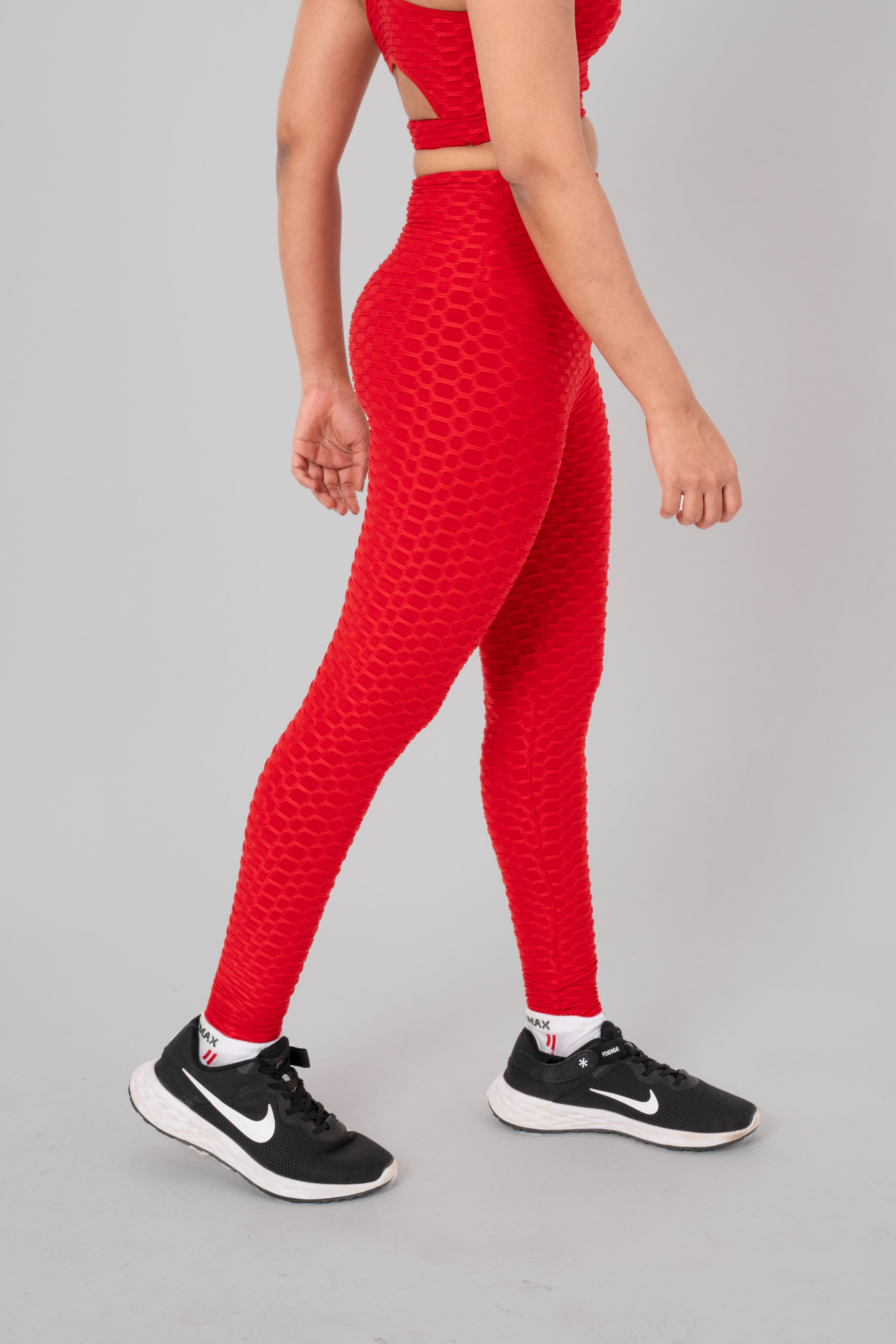 Woman in workout leggings, red - side walking pose emphasizing medium compression and squat proof design.@@@color_Red