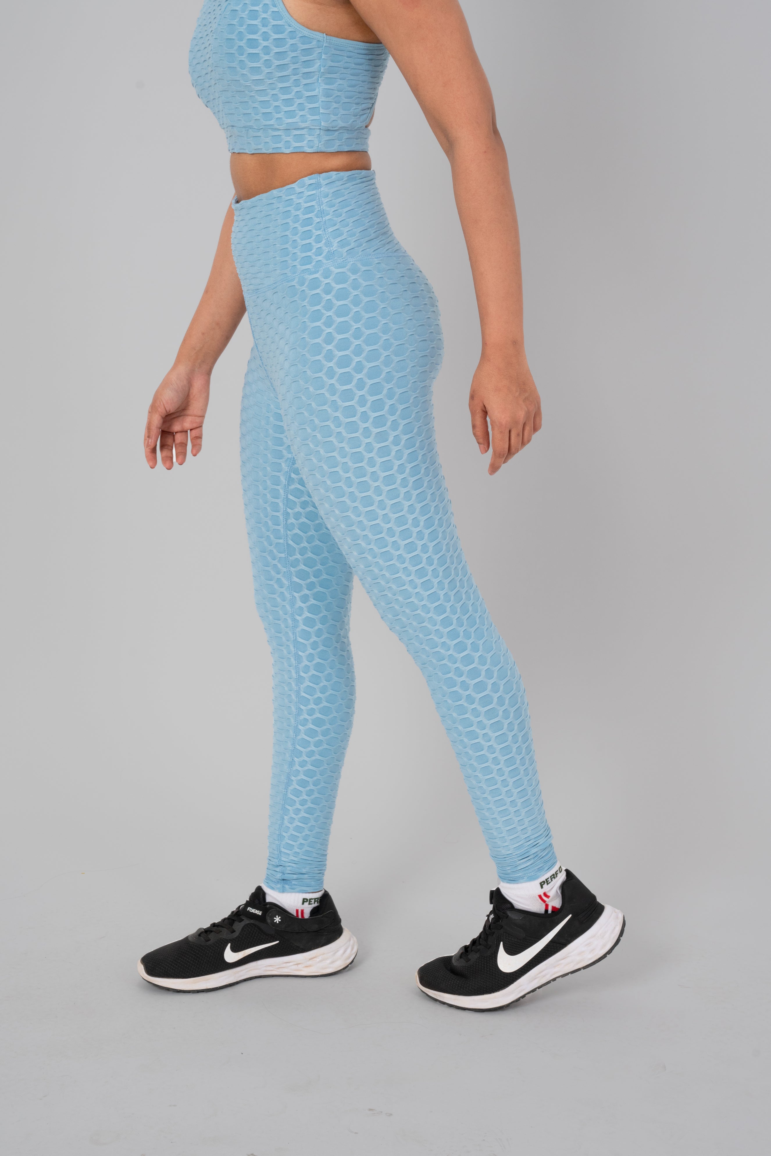 Woman in workout leggings, Sky Blue - side walking pose emphasizing medium compression and squat proof design.@@@color_Sky-Blue