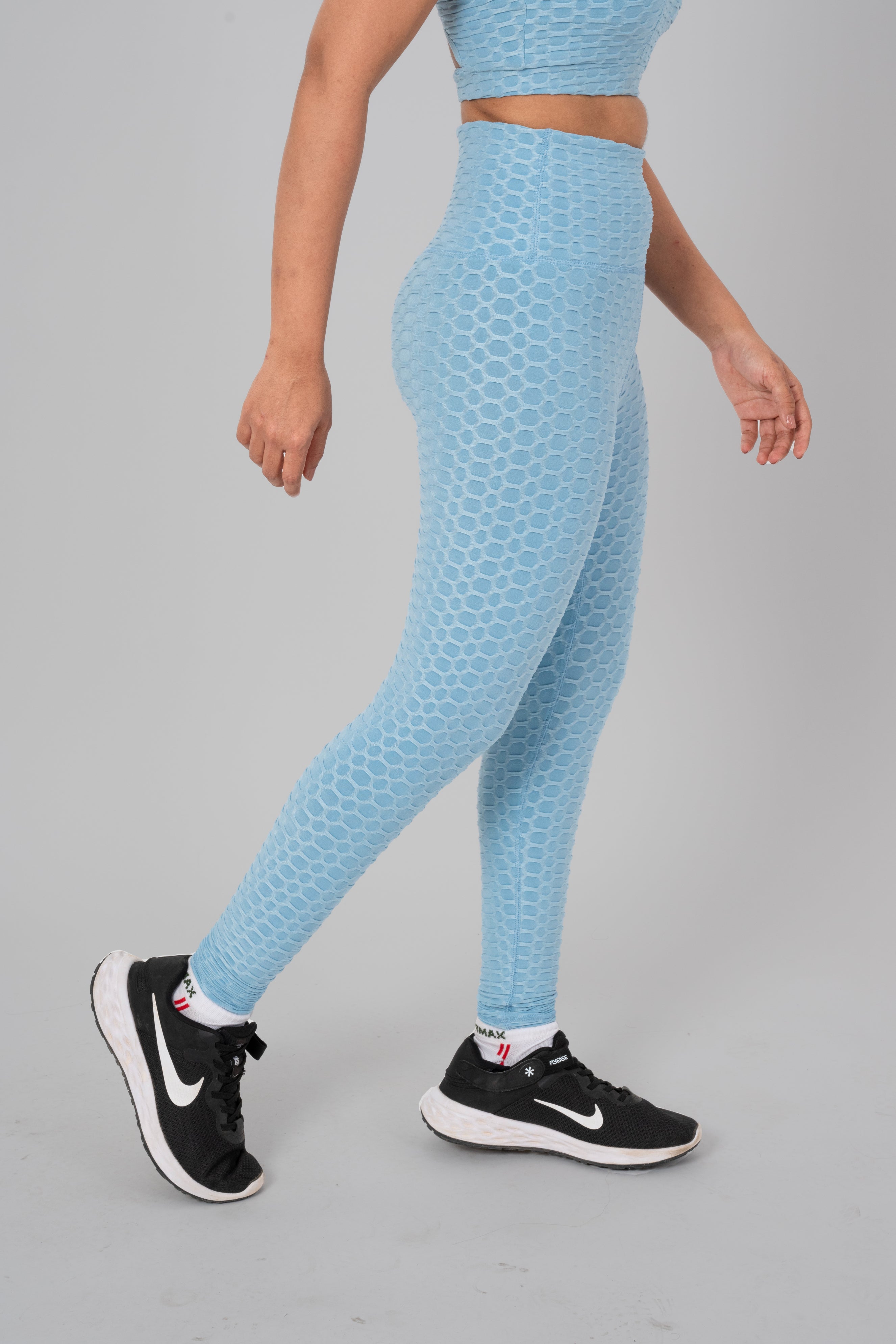 Woman in workout leggings, Sky Blue - side walking pose emphasizing medium compression and squat proof design.@@@color_Sky-Blue