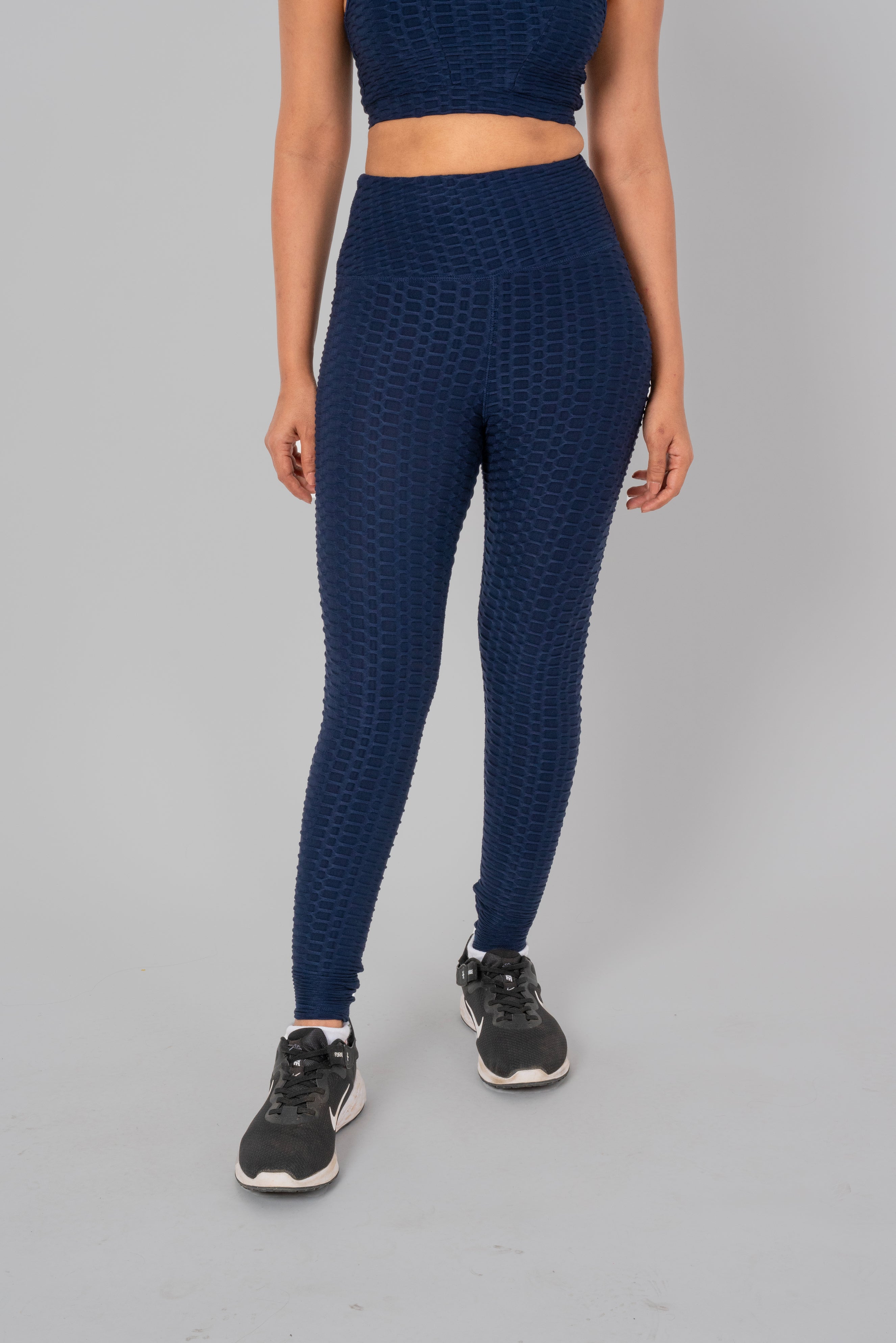 Woman in workout leggings, Navy Blue- front view showing high-waisted fit and anti-camel toe feature.@@@color_navy-blue