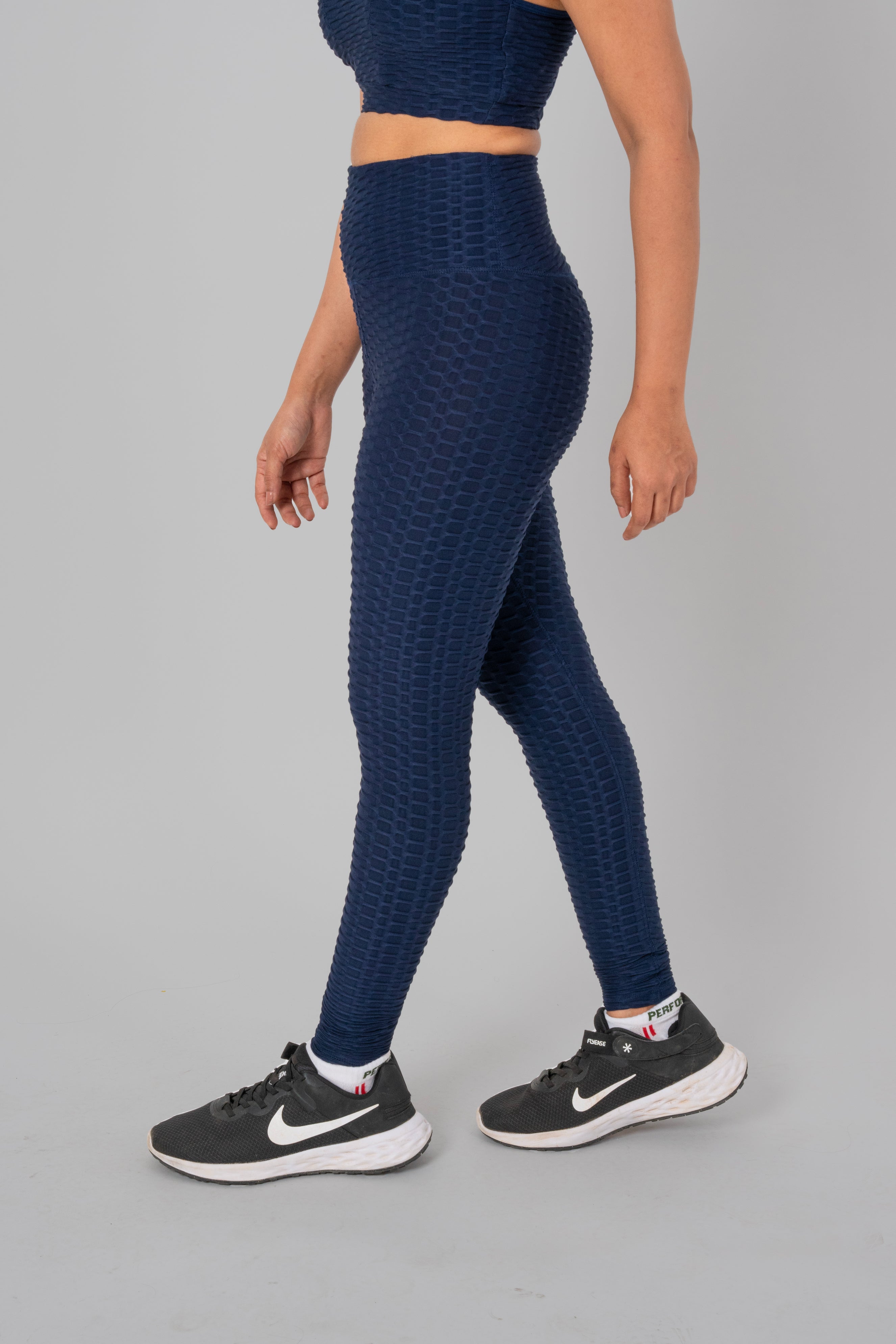 Woman in workout leggings, Navy Blue - side view standing, showing breathable fabric and anti-camel toe feature.@@@color_navy-blue