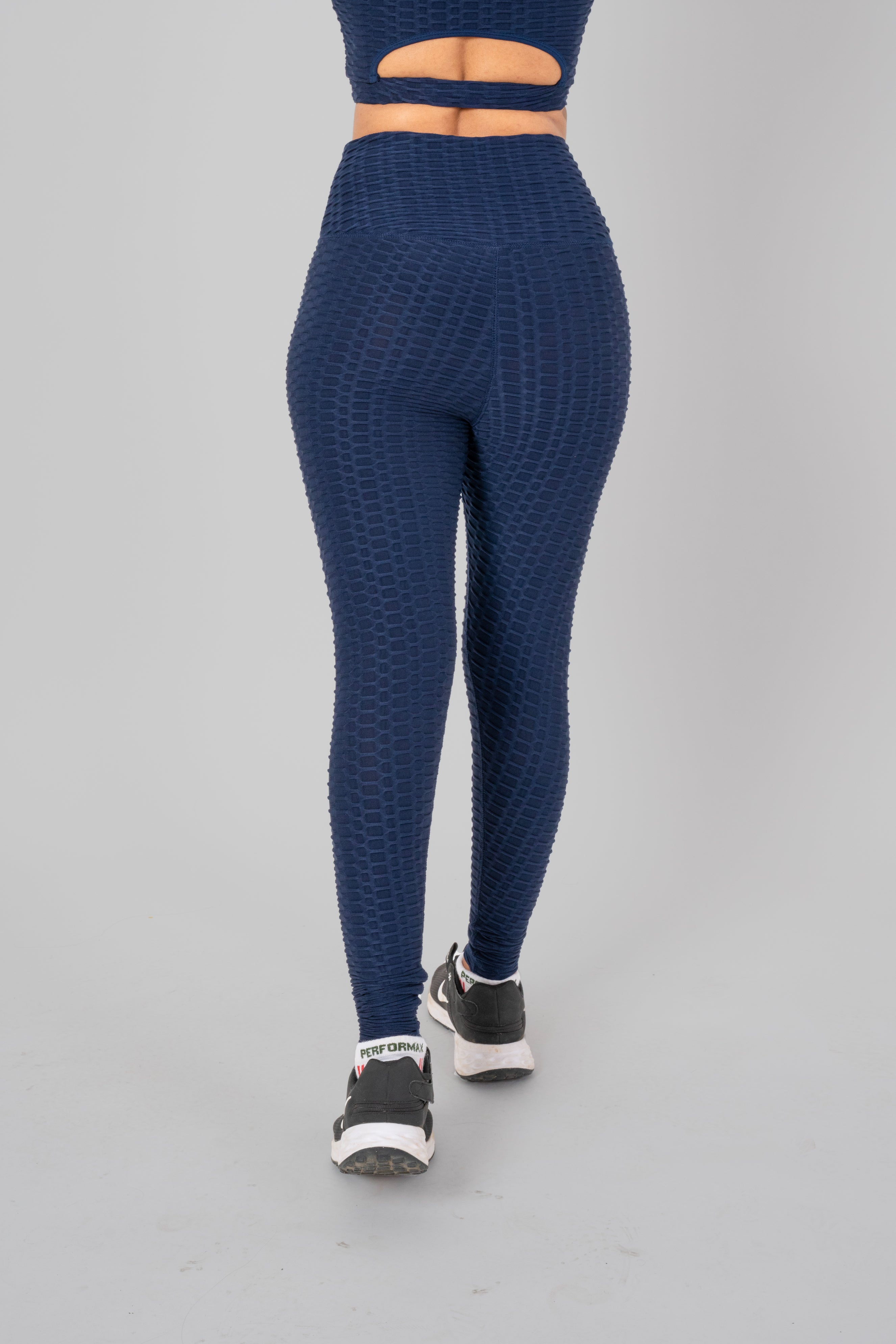 Woman in workout leggings, Navy Blue - back view showcasing and high-waisted support.@@@color_navy-blue