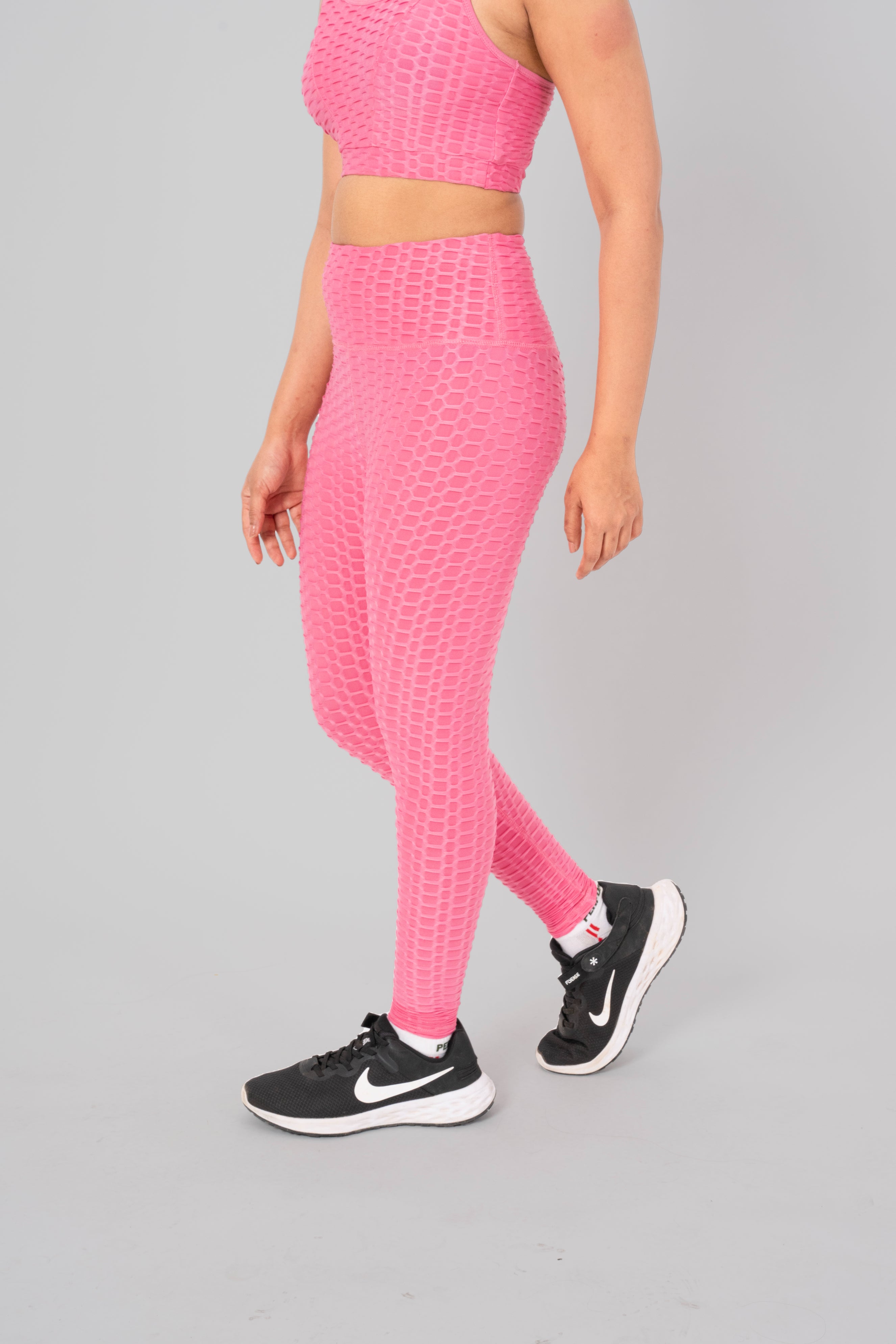 Woman in workout leggings, Pink - side walking pose emphasizing medium compression and squat proof design.@@@color_Pink