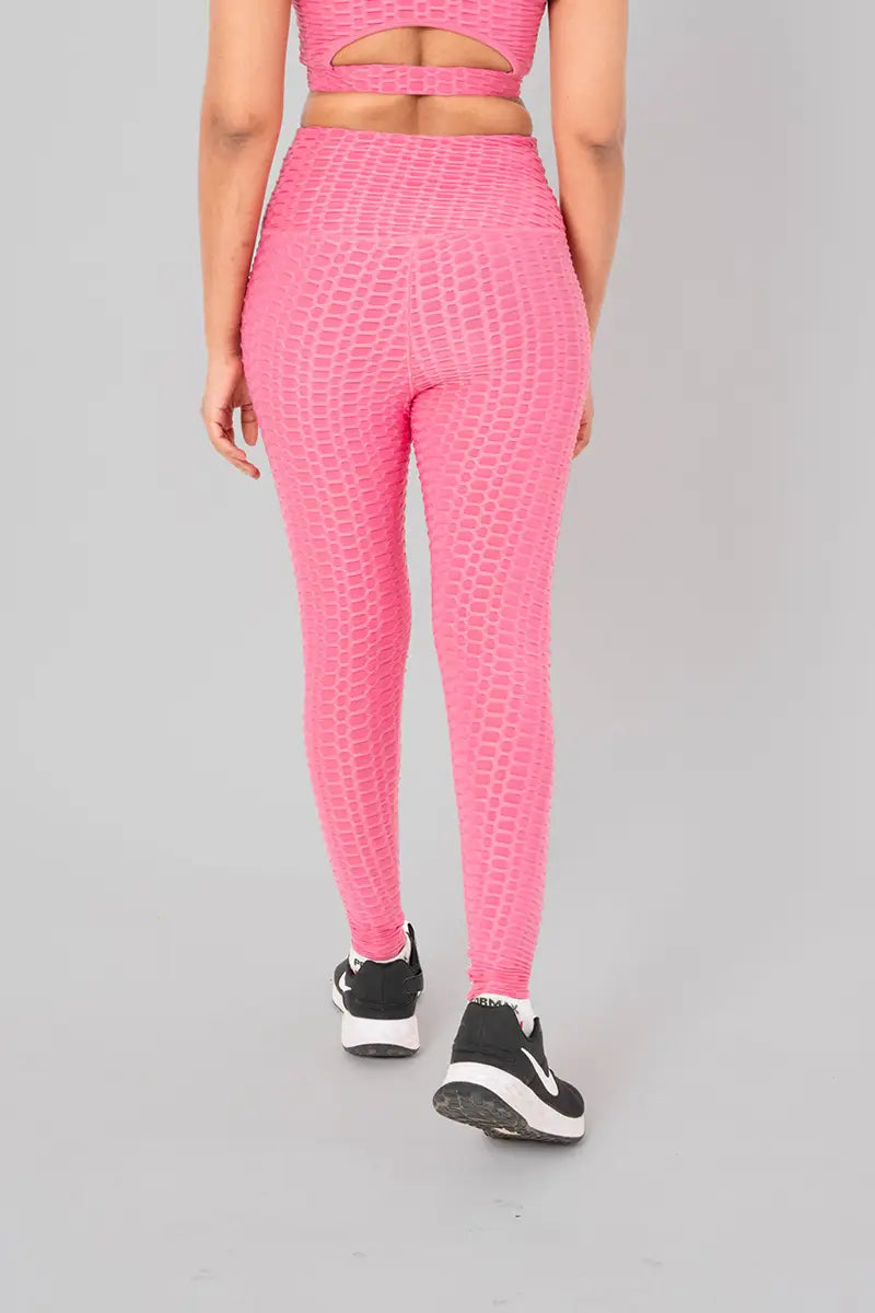 Woman in activewear, pink leggings - back view showing squat-proof feature and anti-camel toe design.