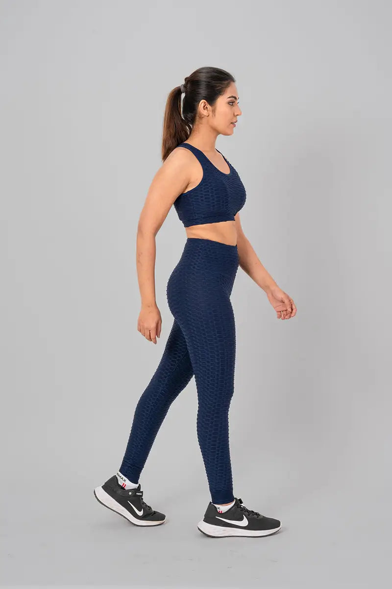 Woman in activewear set, navy blue coord - relaxed front pose emphasizing high-waisted fit and zero transparency.