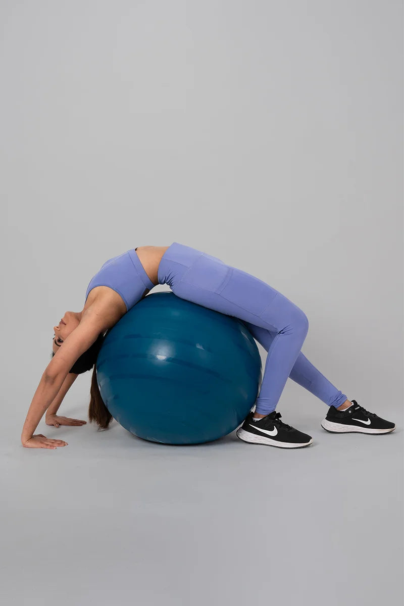 Woman wearing Anywhere Coord Set in Lilac during gym workout on a fitness ball