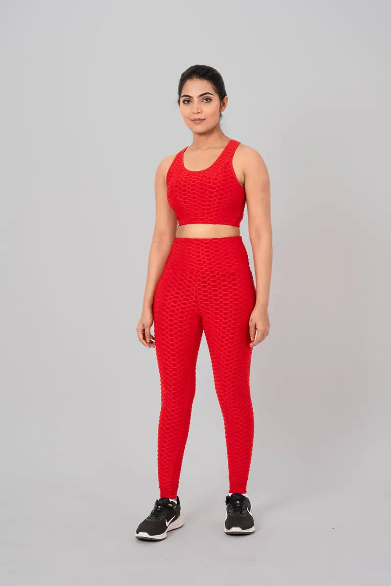 Woman in gym clothes coord set, red - relaxed front pose showcasing moisture-wicking fabric and zero transparency guarantee.