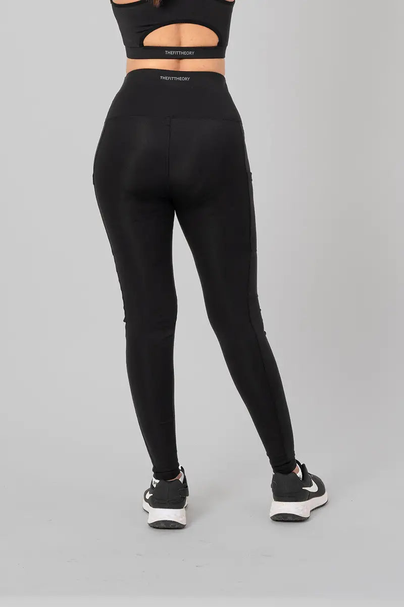 Woman in high waisted black leggings - back view showing squat-proof design and high-waisted fit.