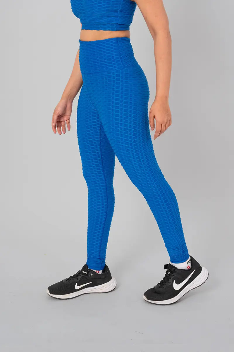 leggings for women, teal blue - walking side view emphasizing medium compression and sweat-wicking properties.