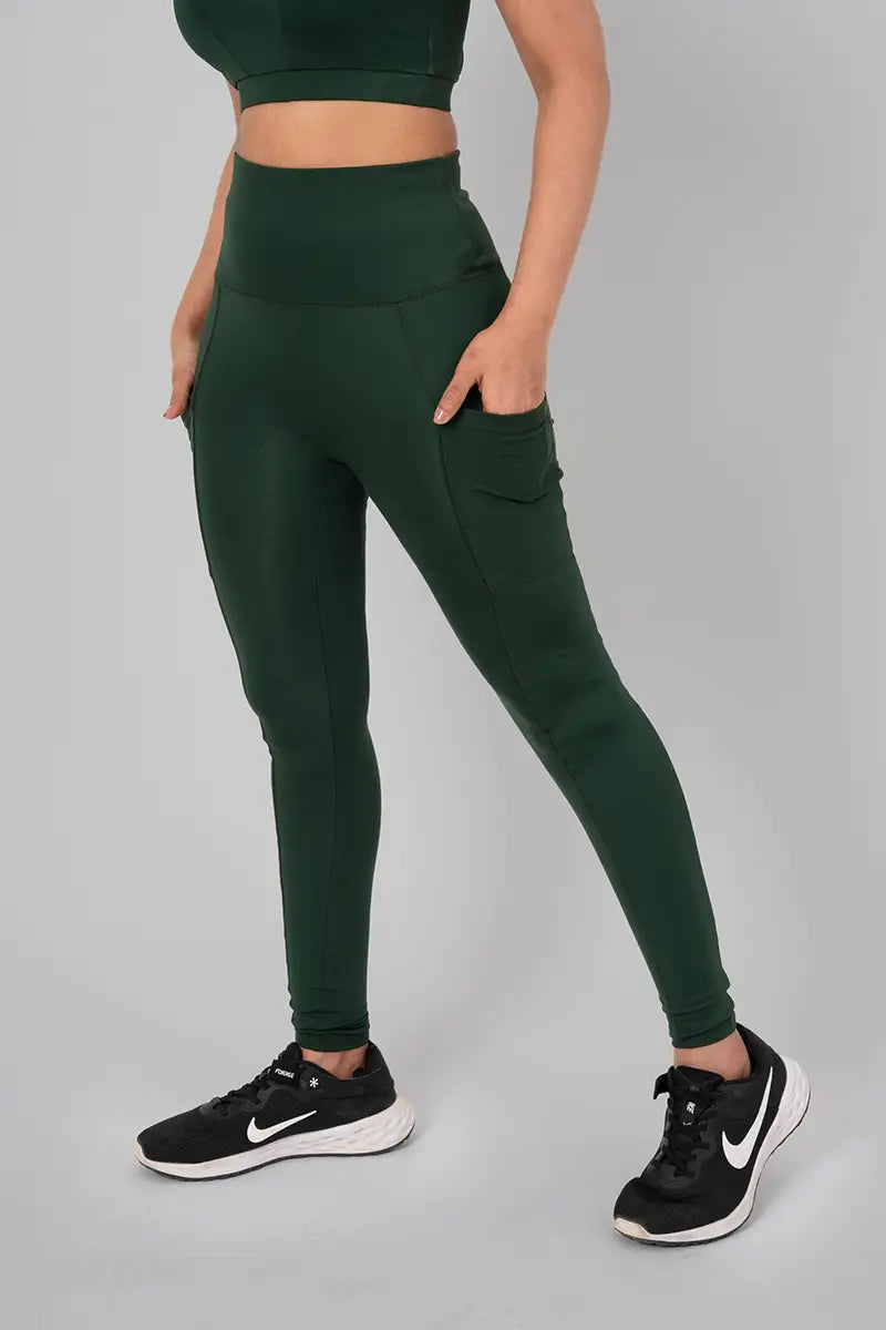 Woman in leggings with pockets, sage - side walking pose demonstrating breathable, stretchable fabric and pocket design.