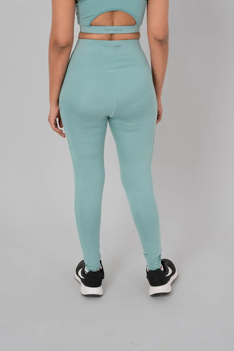 Woman in activewear pants, mist - back view showing squat-proof design and high-waisted fit.