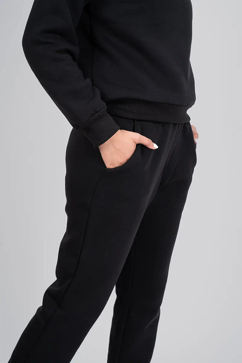 Close-up of pocket on women's gym pants, black jogger - emphasizing functional pocket design and soft fabric.