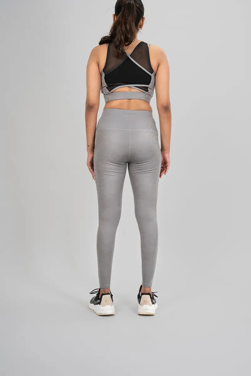 Woman in workout leggings, grey metallic - back view showing squat-proof material and high-waisted fit.