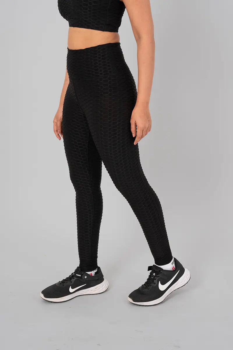 Woman in workout leggings, black - side view standing, showing breathable fabric and anti-camel toe feature.@@@color_Black