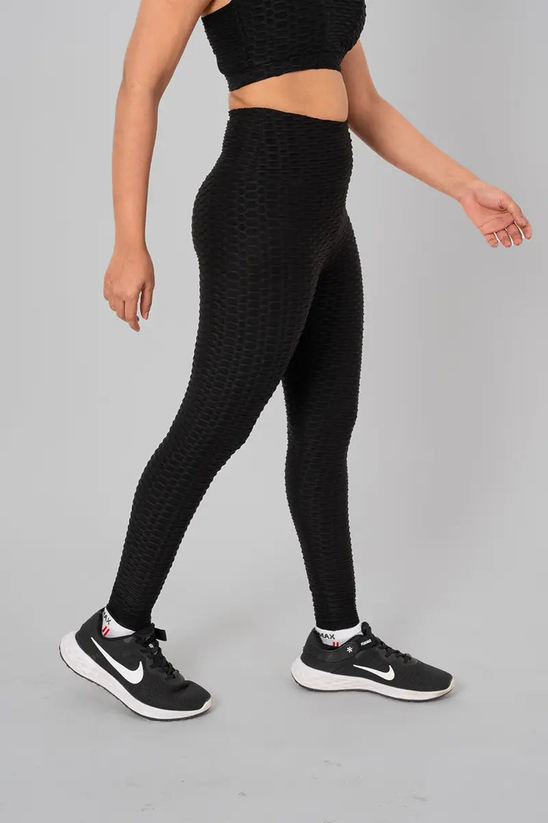 Woman in workout leggings, black - side walking pose emphasizing medium compression and squat proof design.@@@color_Black