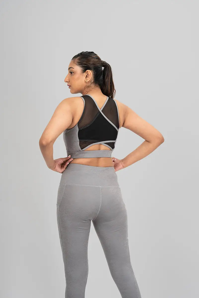 Close-up of waist detail on workout leggings, grey metallic - emphasizing high-waisted design and breathable fabric.